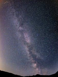 The milky is seen in the sky above a mountain